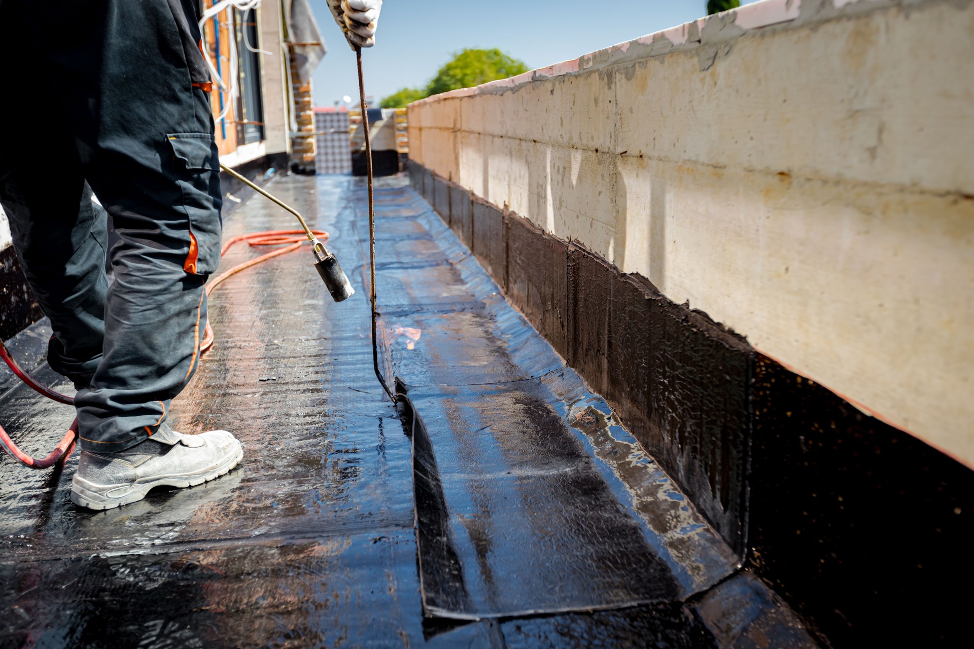 Worker using a gas burner, propane blowtorch to melt and arrange resin